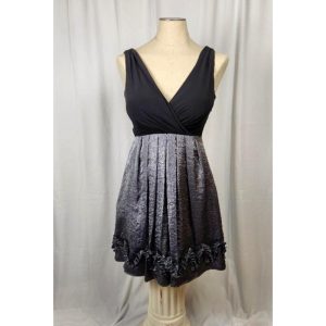 Black formal dress, taffeta like skirt with raised detailing, has under slip